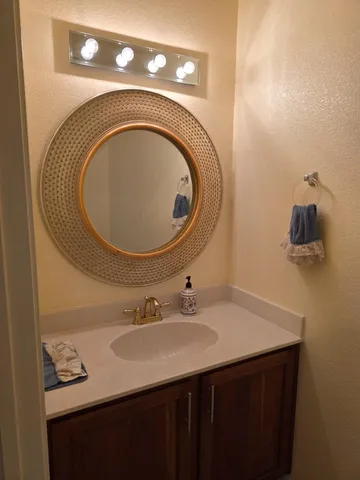 a white toilet sitting next to a white wall