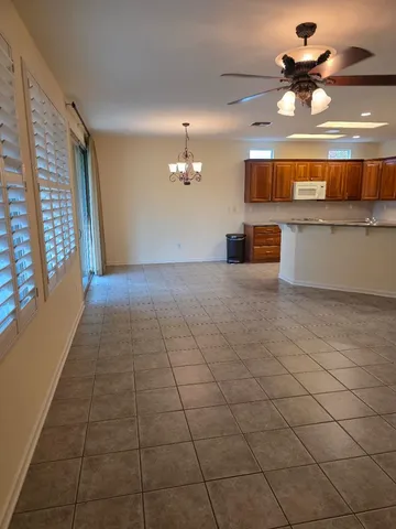 a view of a kitchen with a sink and chandelier fan