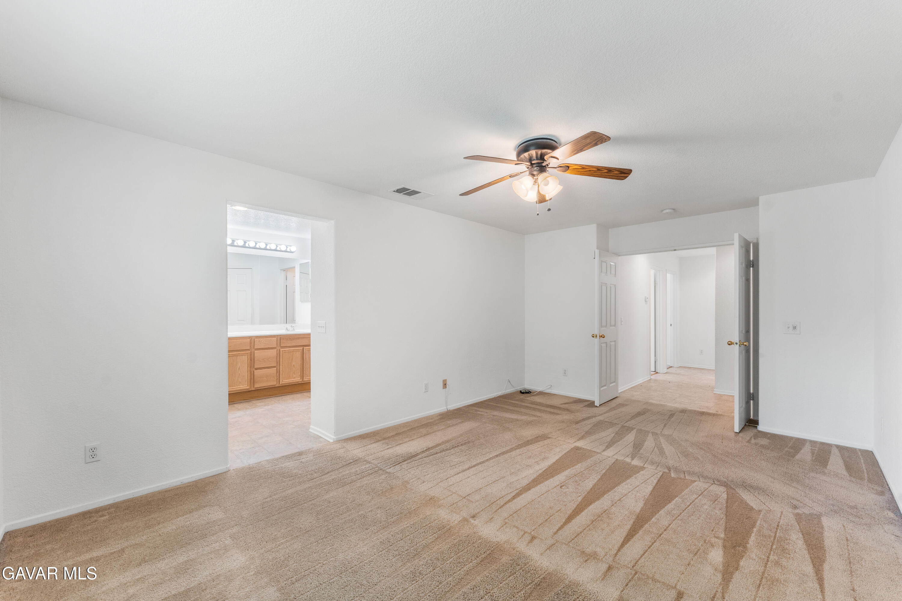 45334 Stadium Lane Lancaster, CA 93535 - Photo 14 of 36 a view of a room with a ceiling fan and a chandelier fan