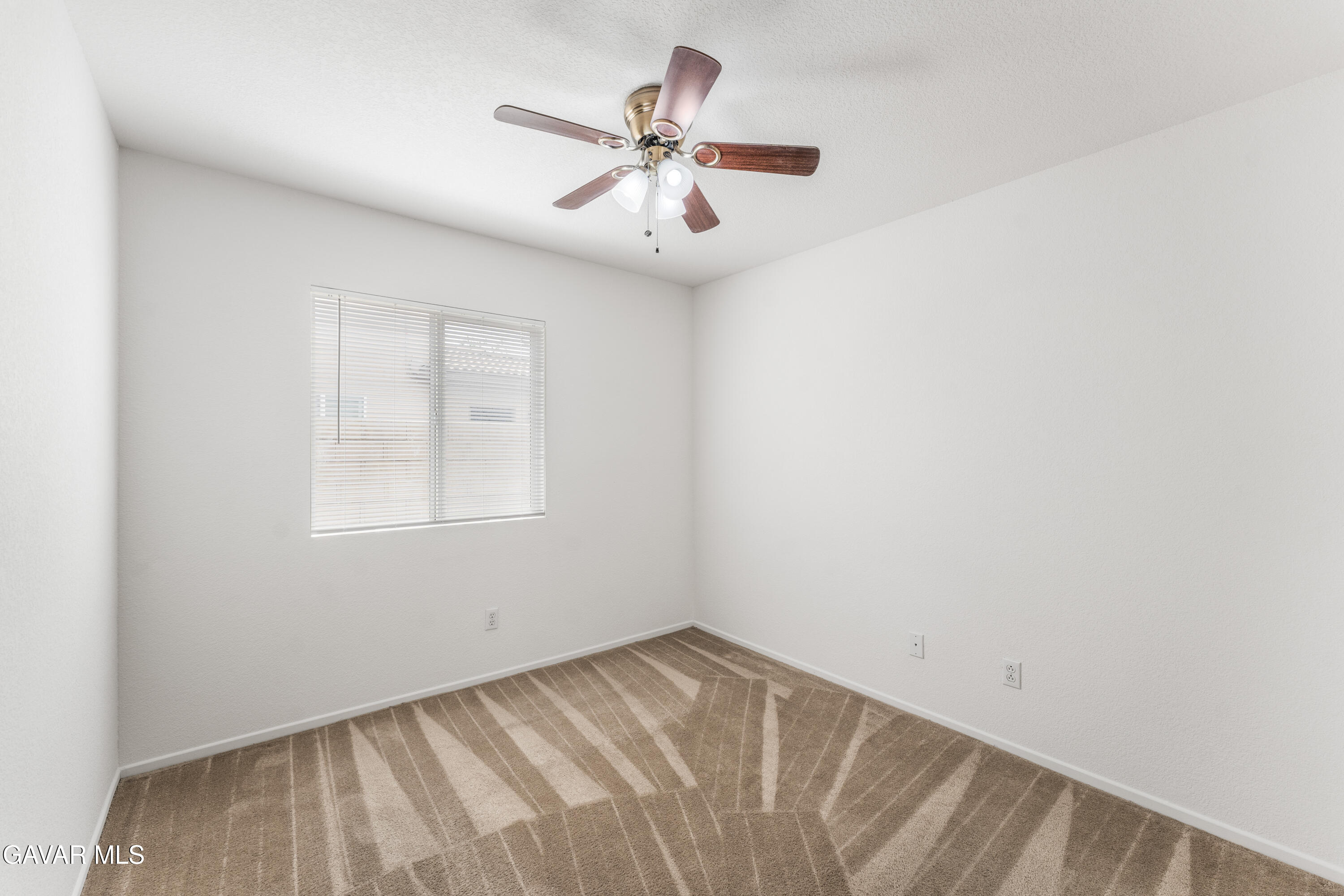 45334 Stadium Lane Lancaster, CA 93535 - Photo 21 of 36 an empty room with chandelier fan and windows