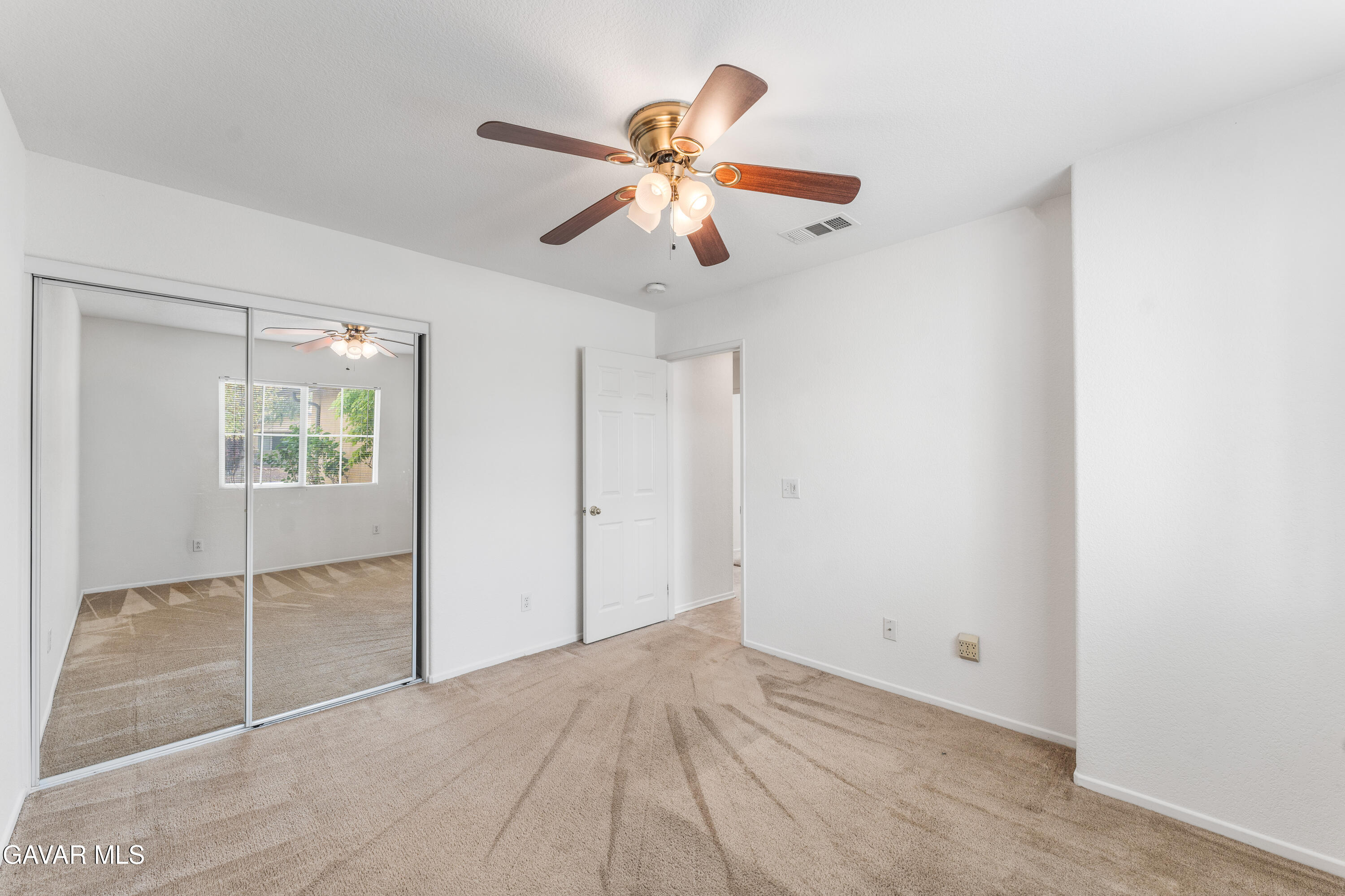 45334 Stadium Lane Lancaster, CA 93535 - Photo 26 of 36 a view of an empty room with window and a ceiling fan