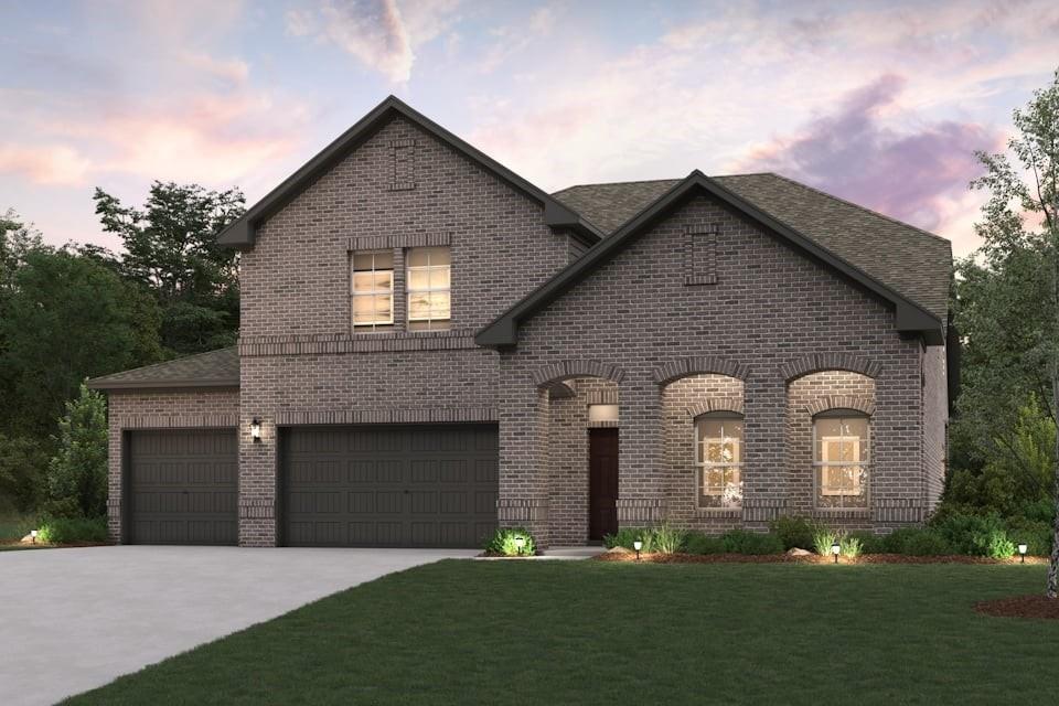 a front view of a house with a garden and yard