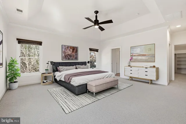 a spacious bedroom with a bed and a chandelier