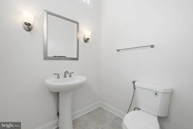 a bathroom with a sink mirror toilet and vanity