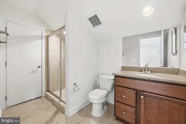 a bathroom with a toilet sink and shower