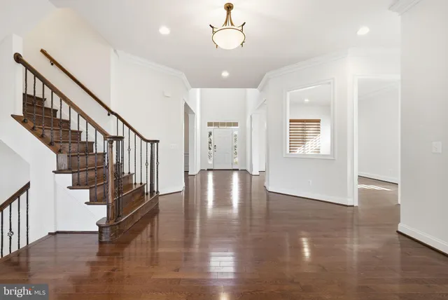 a view of entryway and hall with wooden floor