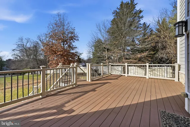 a balcony with wooden floor and fence