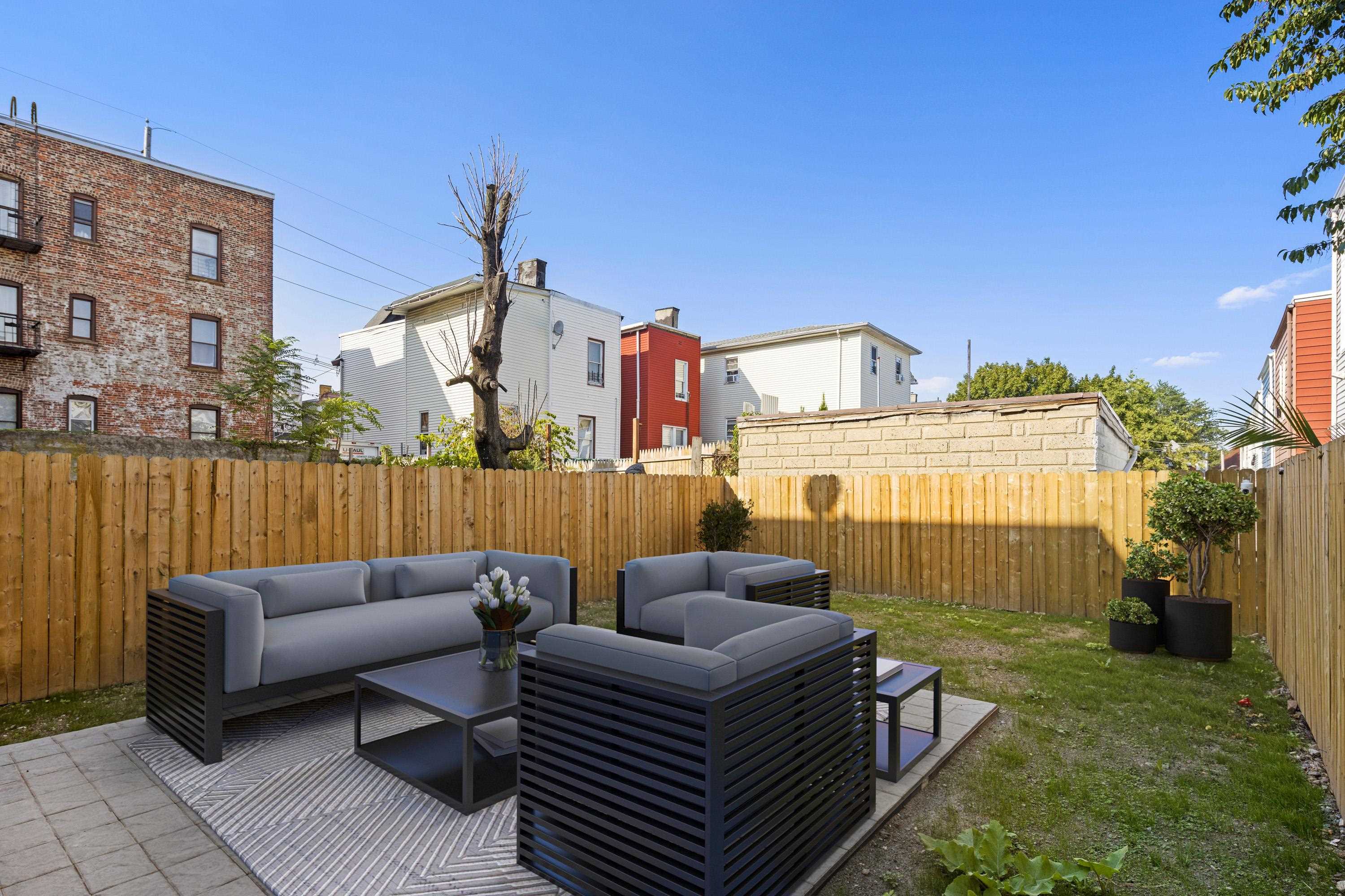 30 Wilkinson Avenue, Unit 1 Jersey City, NJ 07305 - Photo 15 of 17 a view of a terrace with couches chairs and a table