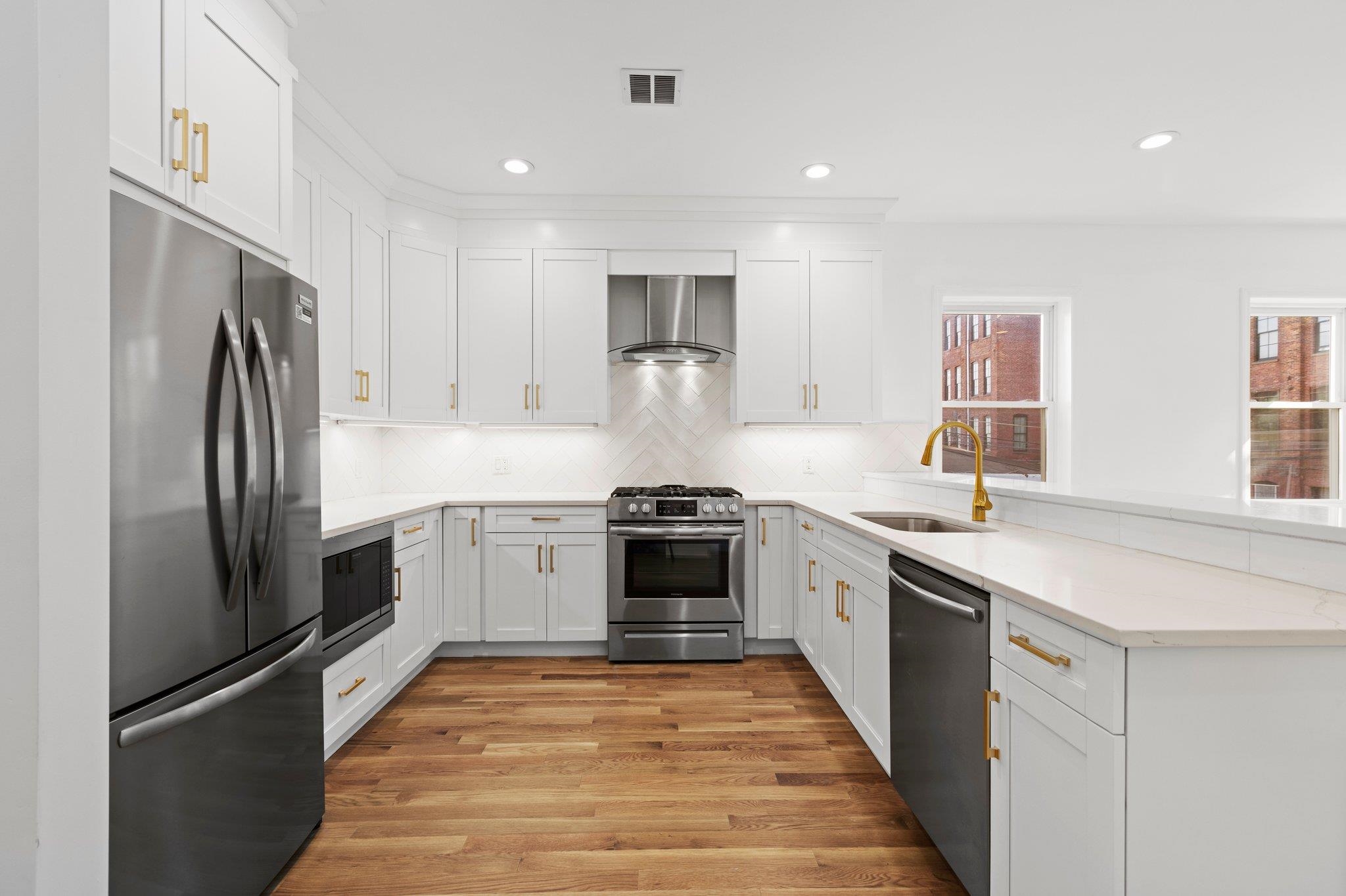 30 Wilkinson Avenue, Unit 1 Jersey City, NJ 07305 - Photo 3 of 17 a kitchen with stainless steel appliances a refrigerator sink and stove