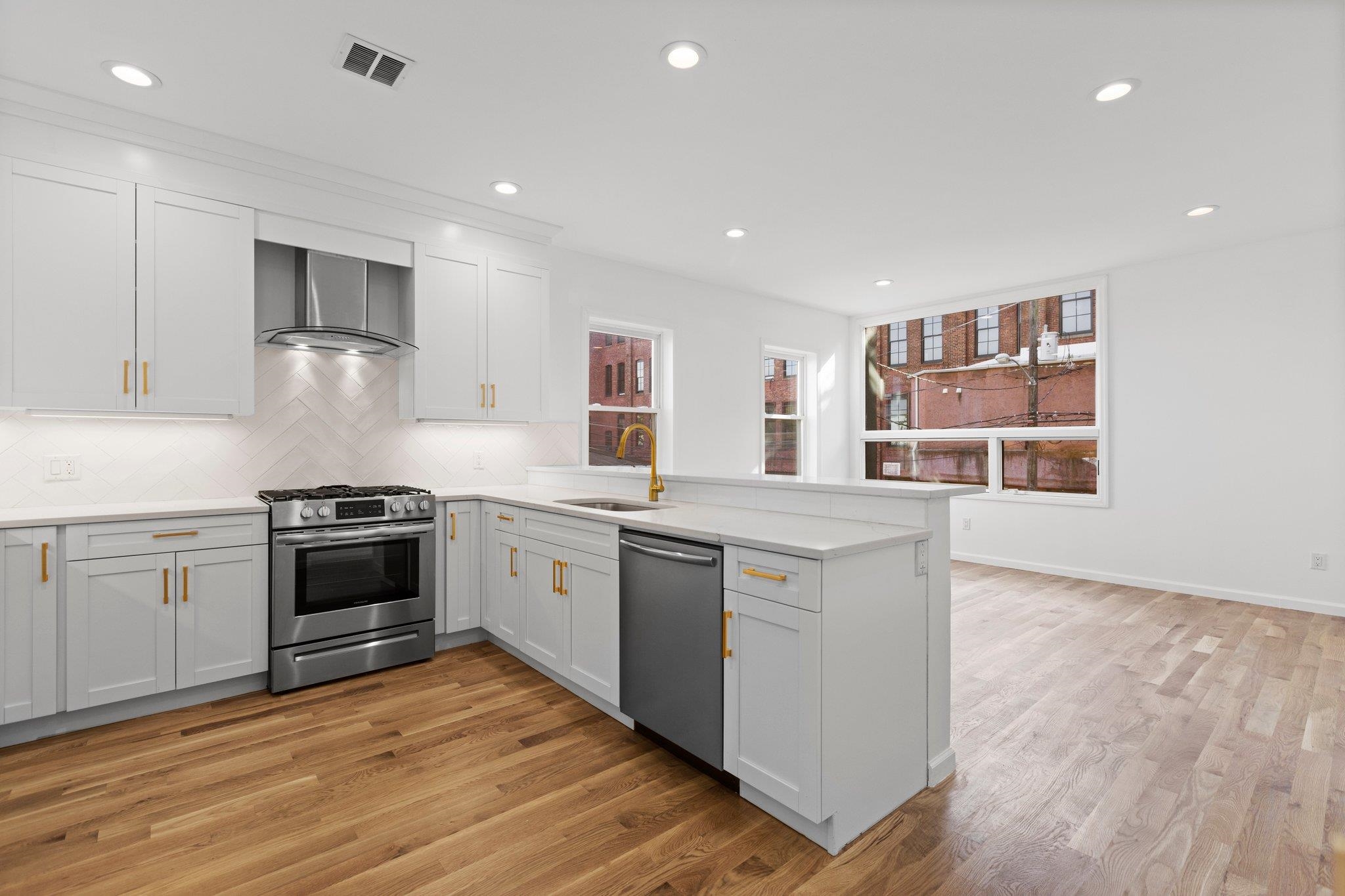 30 Wilkinson Avenue, Unit 1 Jersey City, NJ 07305 - Photo 4 of 17 a kitchen with stainless steel appliances granite countertop a stove and a sink