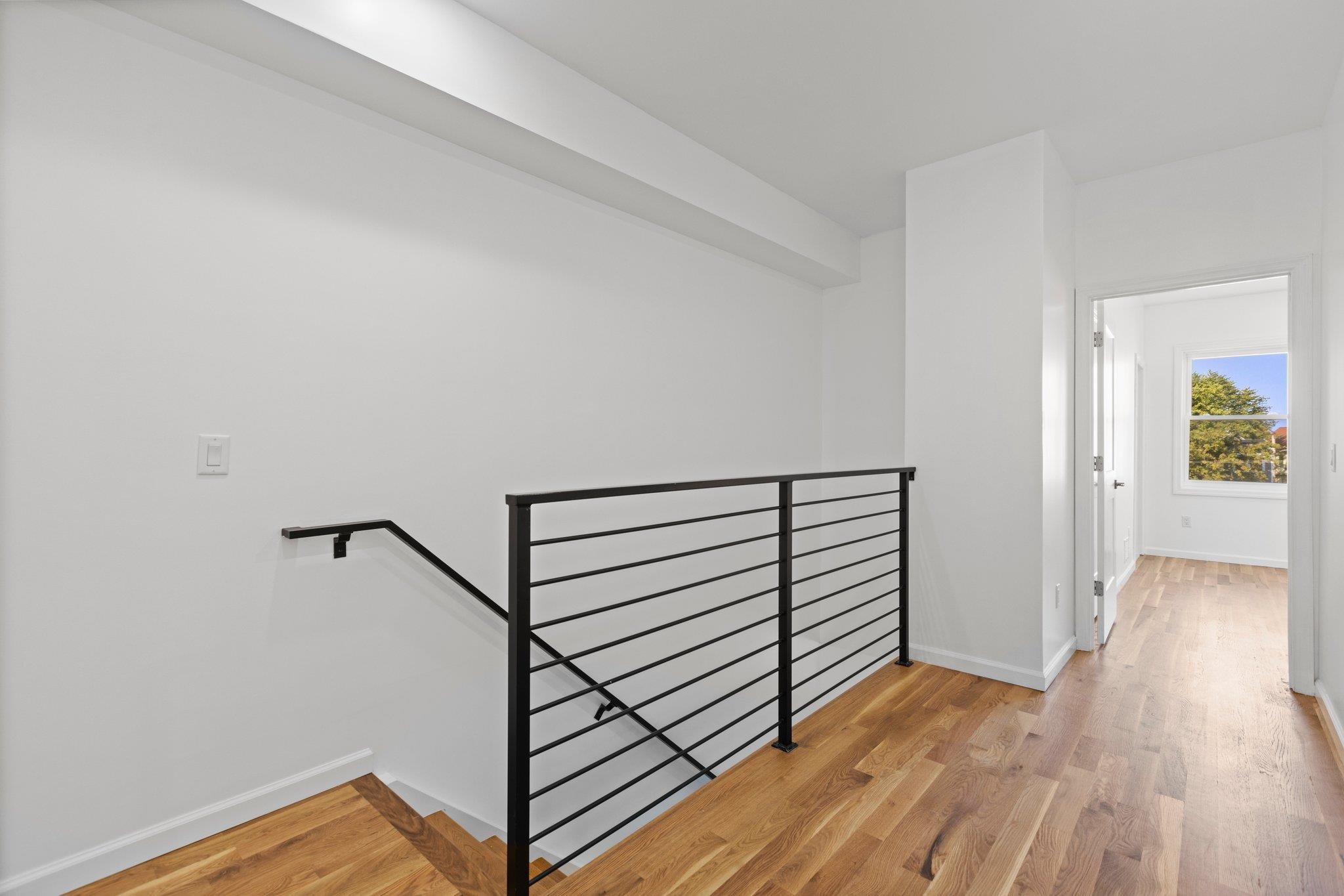 30 Wilkinson Avenue, Unit 1 Jersey City, NJ 07305 - Photo 5 of 17 a view of a hallway with wooden floor and staircase
