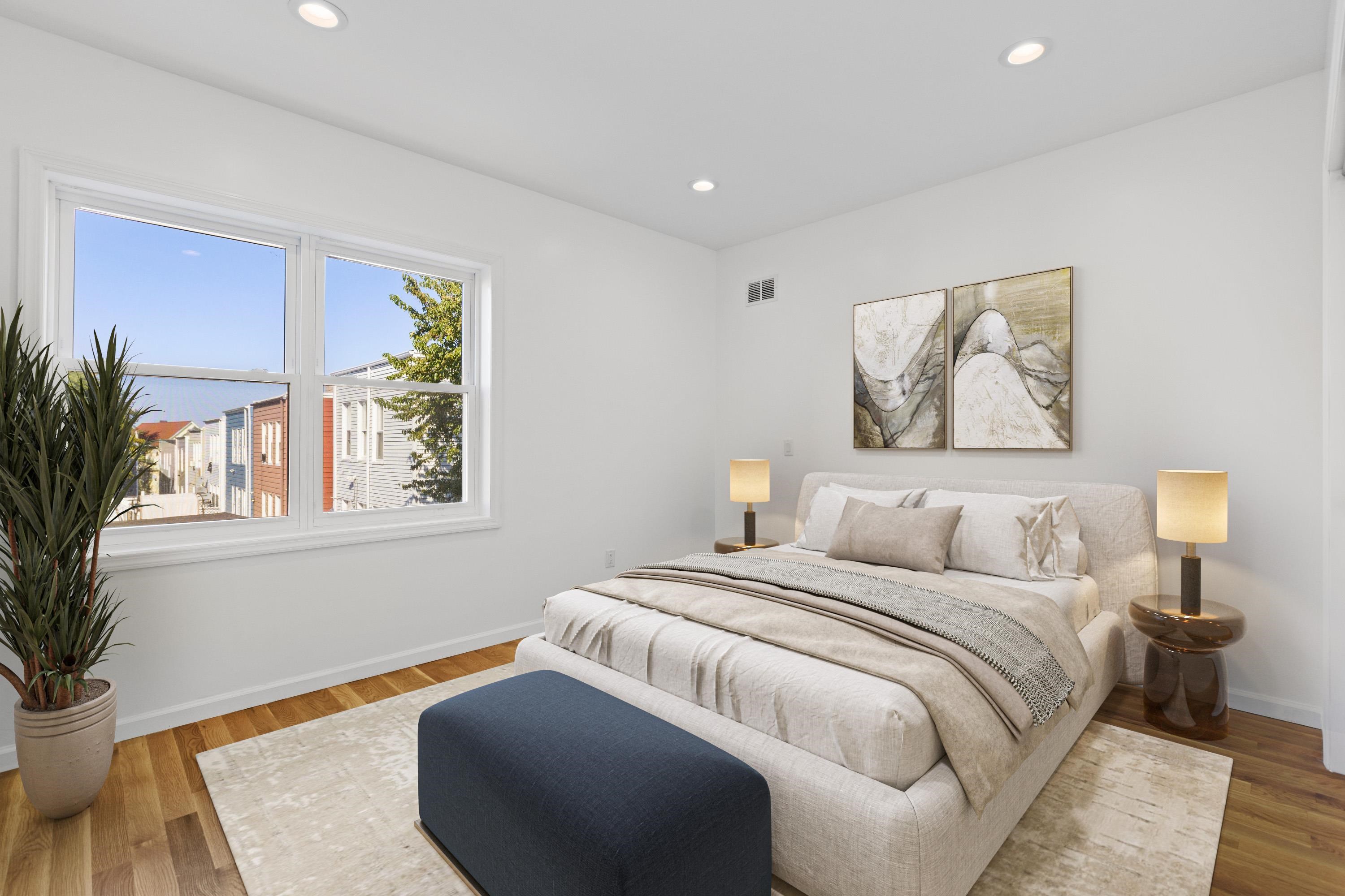 30 Wilkinson Avenue, Unit 1 Jersey City, NJ 07305 - Photo 6 of 17 a bedroom with a bed and a painting on the wall