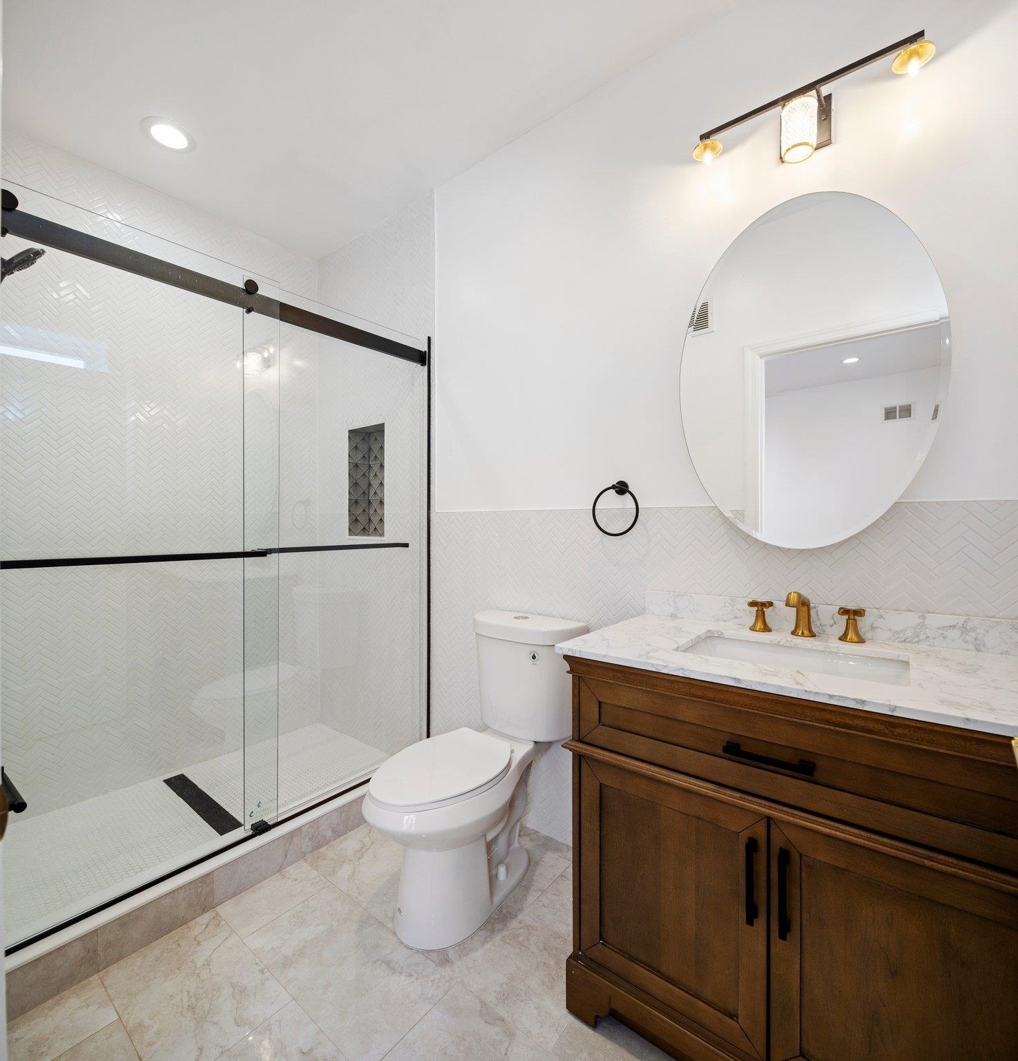 30 Wilkinson Avenue, Unit 1 Jersey City, NJ 07305 - Photo 8 of 17 a bathroom with a toilet a sink and mirror