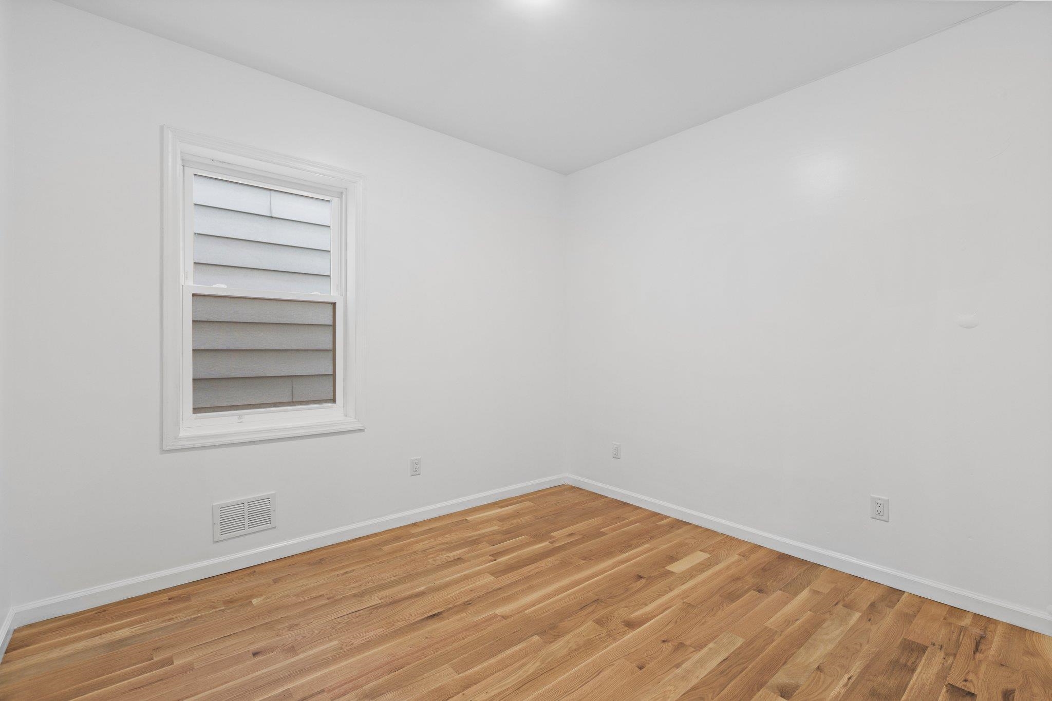30 Wilkinson Avenue, Unit 1 Jersey City, NJ 07305 - Photo 10 of 17 a view of empty room with wooden floor and fan