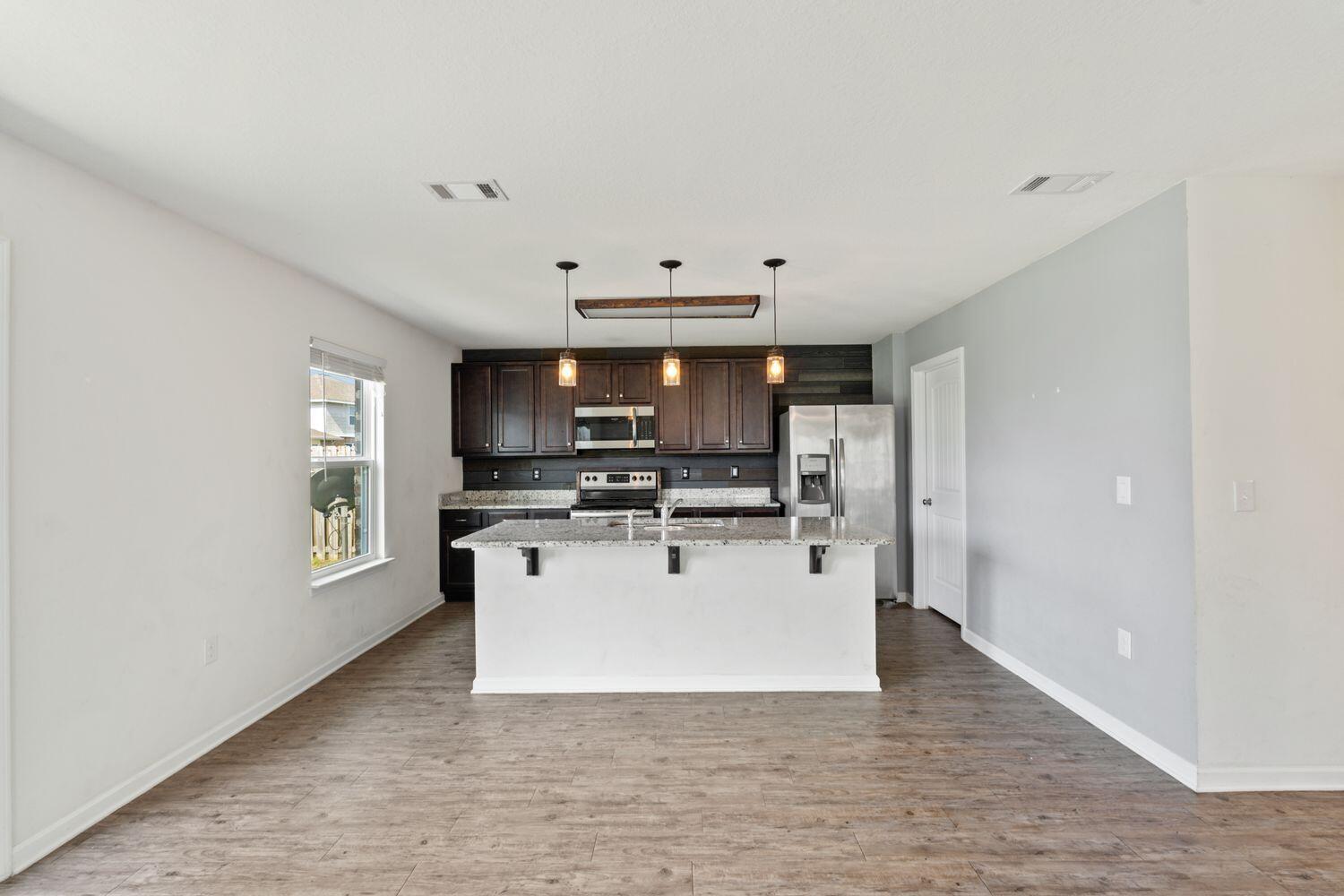 737 Widgeon Way Crestview, FL 32539 - Photo 11 of 36 a view of kitchen with microwave oven a sink and dishwasher