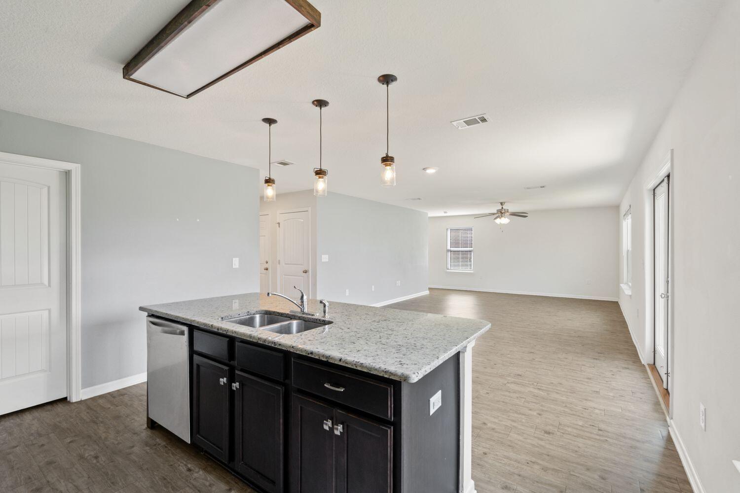 737 Widgeon Way Crestview, FL 32539 - Photo 12 of 36 a kitchen with a sink a counter top space and cabinets