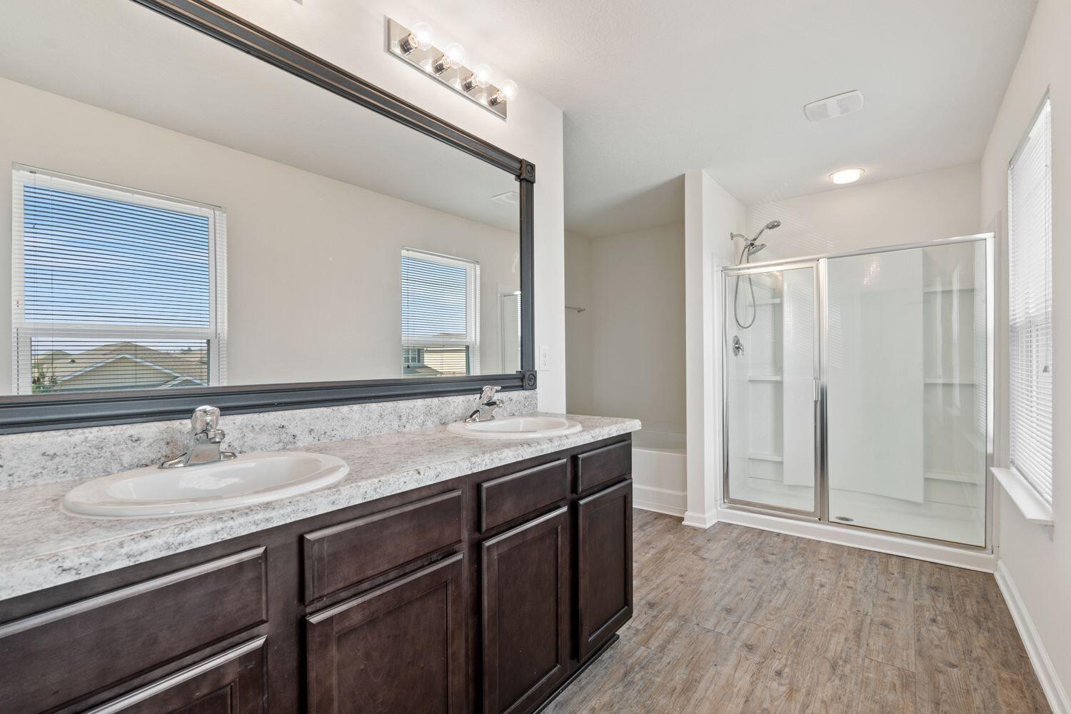 737 Widgeon Way Crestview, FL 32539 - Photo 18 of 36 a bathroom with a granite countertop sink mirror and double