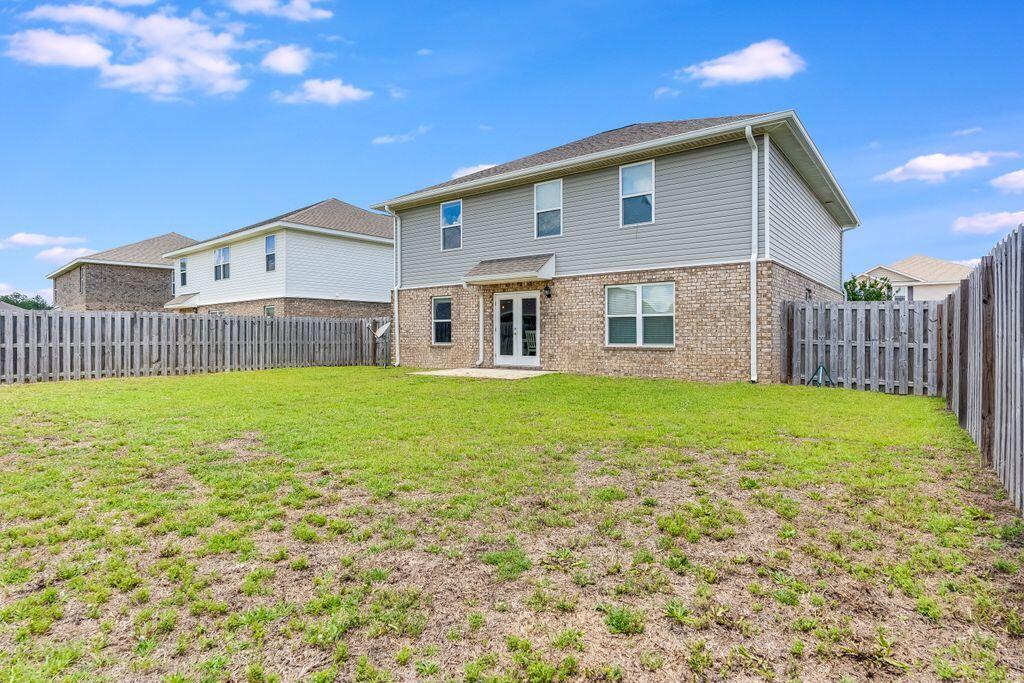 737 Widgeon Way Crestview, FL 32539 - Photo 34 of 36 a front view of a house with garden