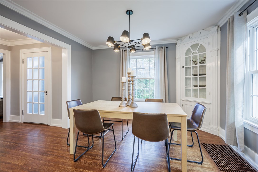 387 Kilbourn Road Rochester, NY 14618 - Photo 9 of 42 Rich hardwood flooring complements a built-in corner hutch and detailed crown moldings.