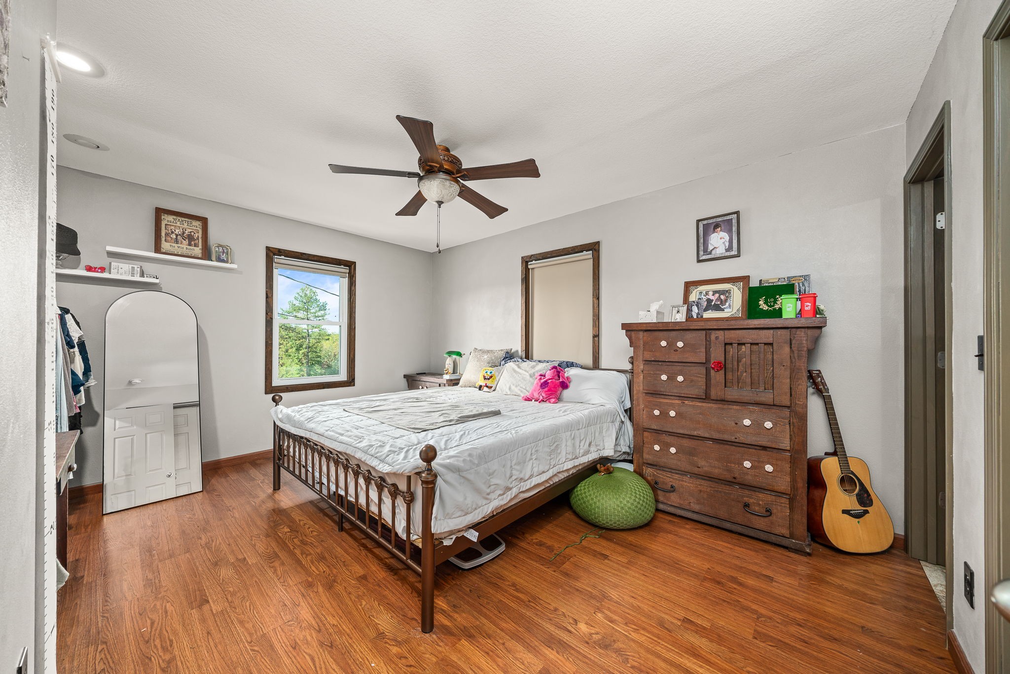 944 Flat Rock Road Crossville, TN 38572 - Photo 14 of 51 a bedroom with a bed a mirror on the dresser and floor