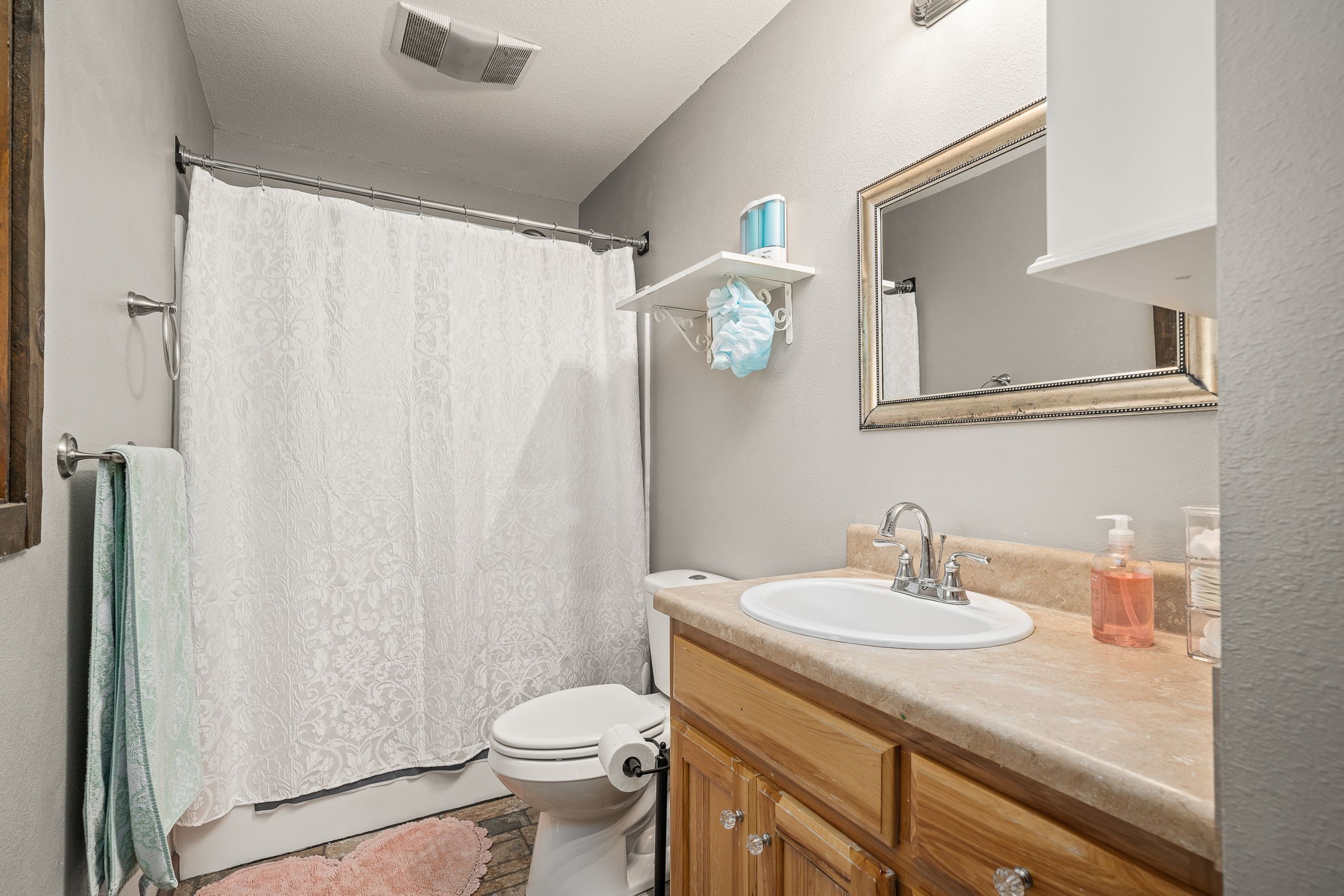 944 Flat Rock Road Crossville, TN 38572 - Photo 16 of 51 a bathroom with a sink a toilet and shower curtain