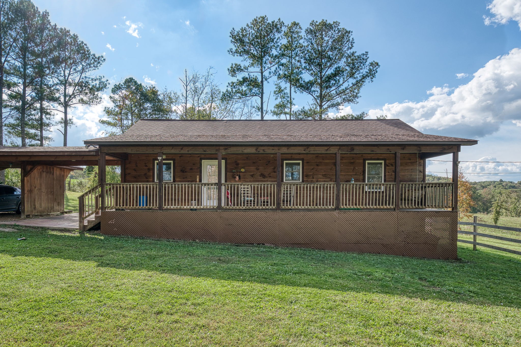 944 Flat Rock Road Crossville, TN 38572 - Photo 23 of 51 a front view of a house with a yard and porch