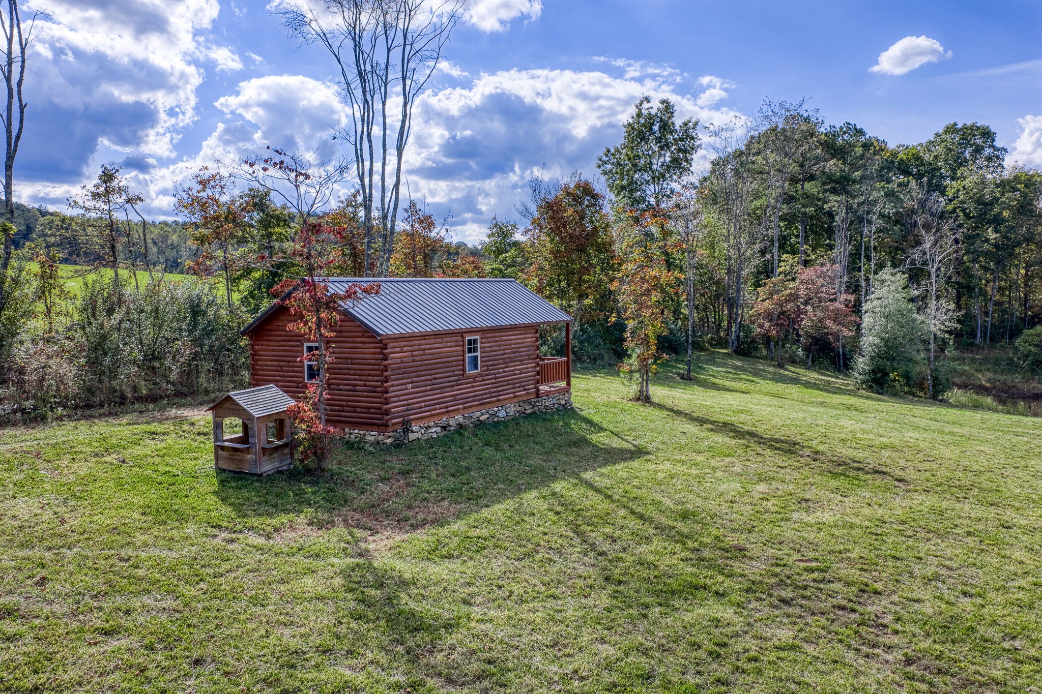 944 Flat Rock Road Crossville, TN 38572 - Photo 34 of 51 a wooden bench sitting in the middle of a yard