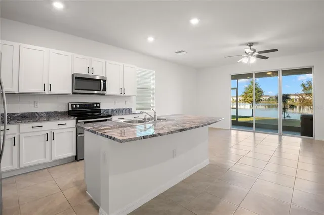 a kitchen with stainless steel appliances granite countertop a stove and a sink