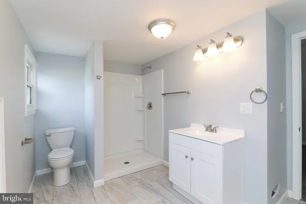 a view of a sink a mirror and cabinets