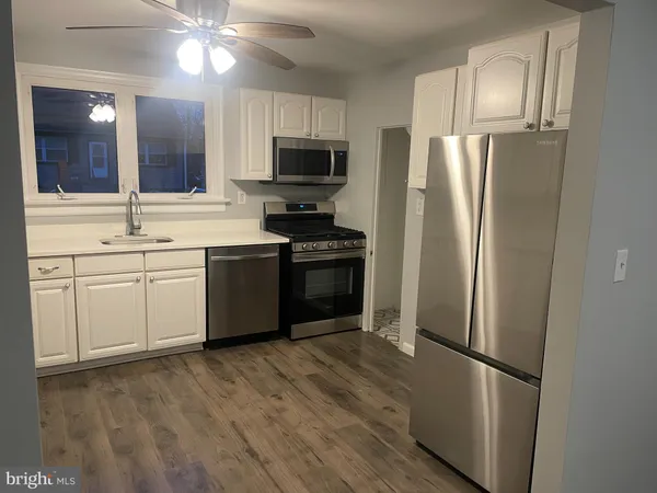 a kitchen with stainless steel appliances a refrigerator stove and sink