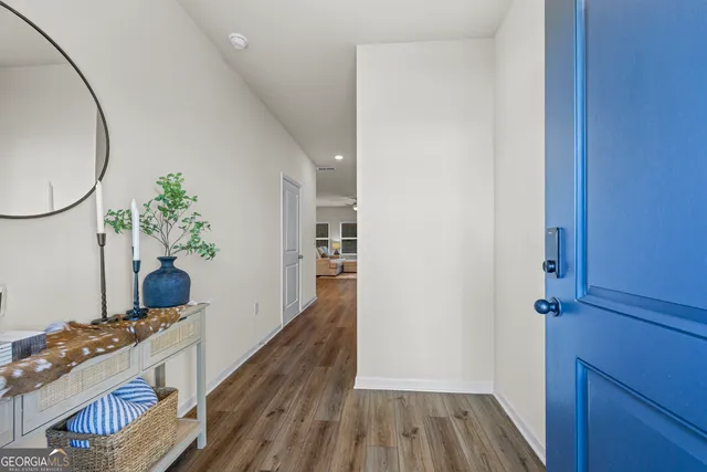 a kitchen with kitchen island granite countertop a table chairs microwave and cabinets