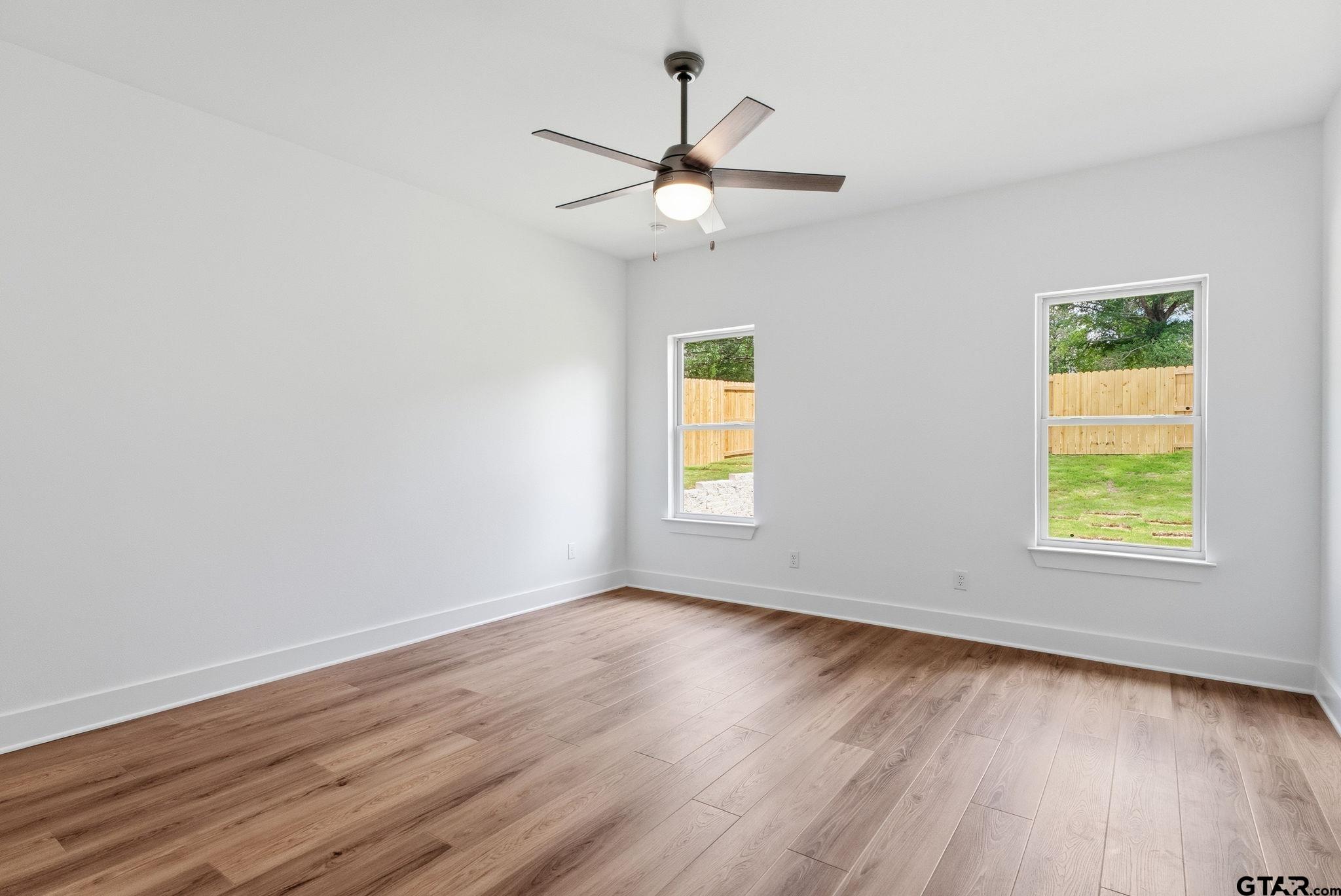 2968 Calloway Road Tyler, TX 75701 - Photo 9 of 24 a view of an empty room with wooden floor and a window