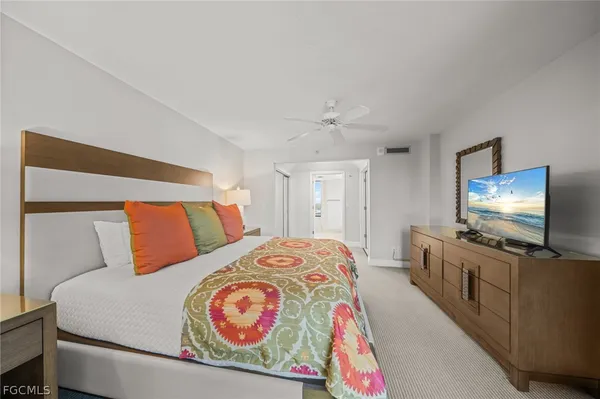 a bedroom with a bed and a flat screen tv