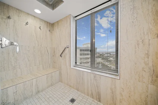 a bathroom with a shower and a window