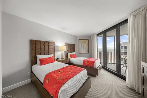 a bedroom with a bed and glass window