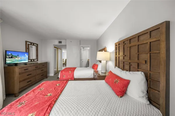 a bedroom with a large bed and a dresser