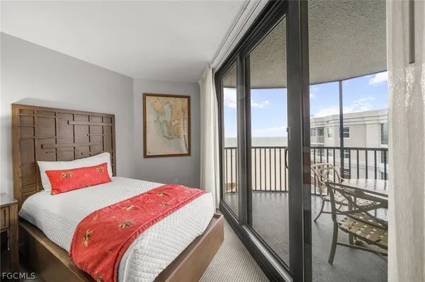 a bedroom with a large bed and a large window