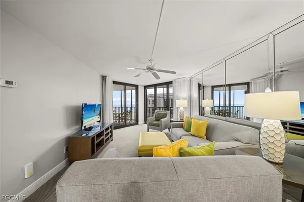 a living room with furniture a couch and a flat screen tv