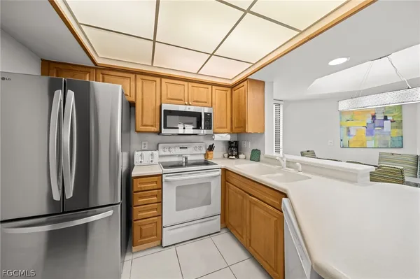 a kitchen with stainless steel appliances granite countertop a refrigerator sink stove microwave and cabinets