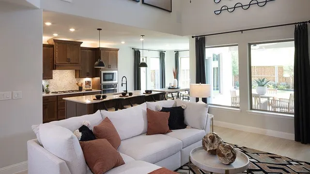 a living room with furniture and kitchen view