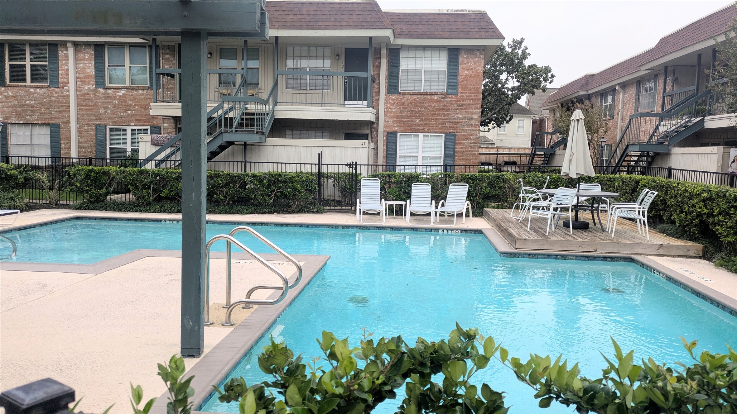 845 Augusta Drive, Unit 17 Houston, TX 77057 - Photo 16 of 19 a view of a swimming pool with a patio
