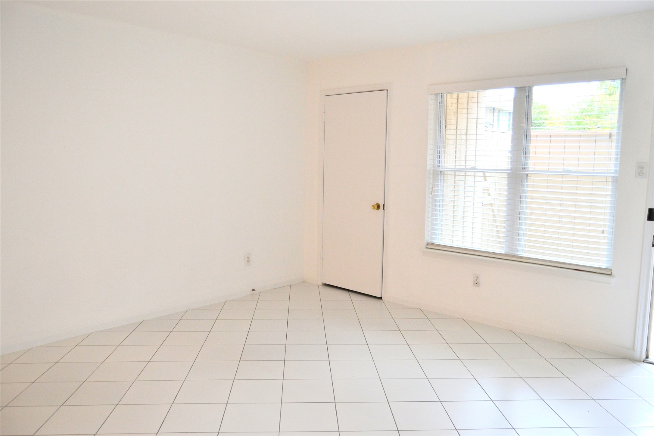 845 Augusta Drive, Unit 17 Houston, TX 77057 - Photo 4 of 19 an empty room with white walls and tiles