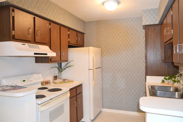 a kitchen with a sink a refrigerator and a stove