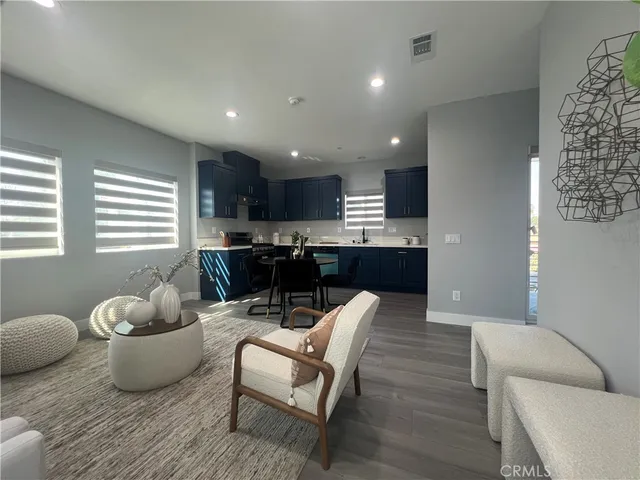 a living room with furniture and kitchen view