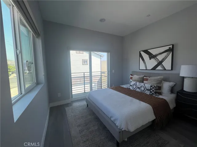 a bedroom with a bed and a large window