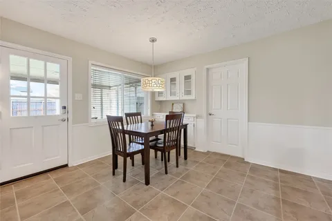 a view of a dining room with furniture and window