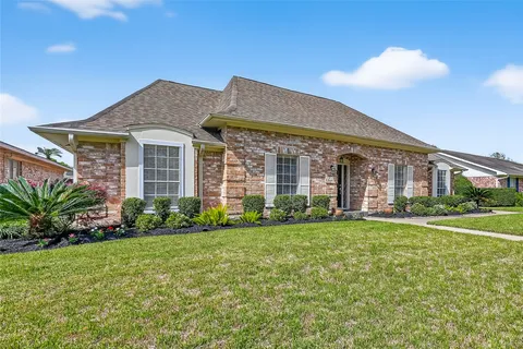 a view of a brick house with a yard