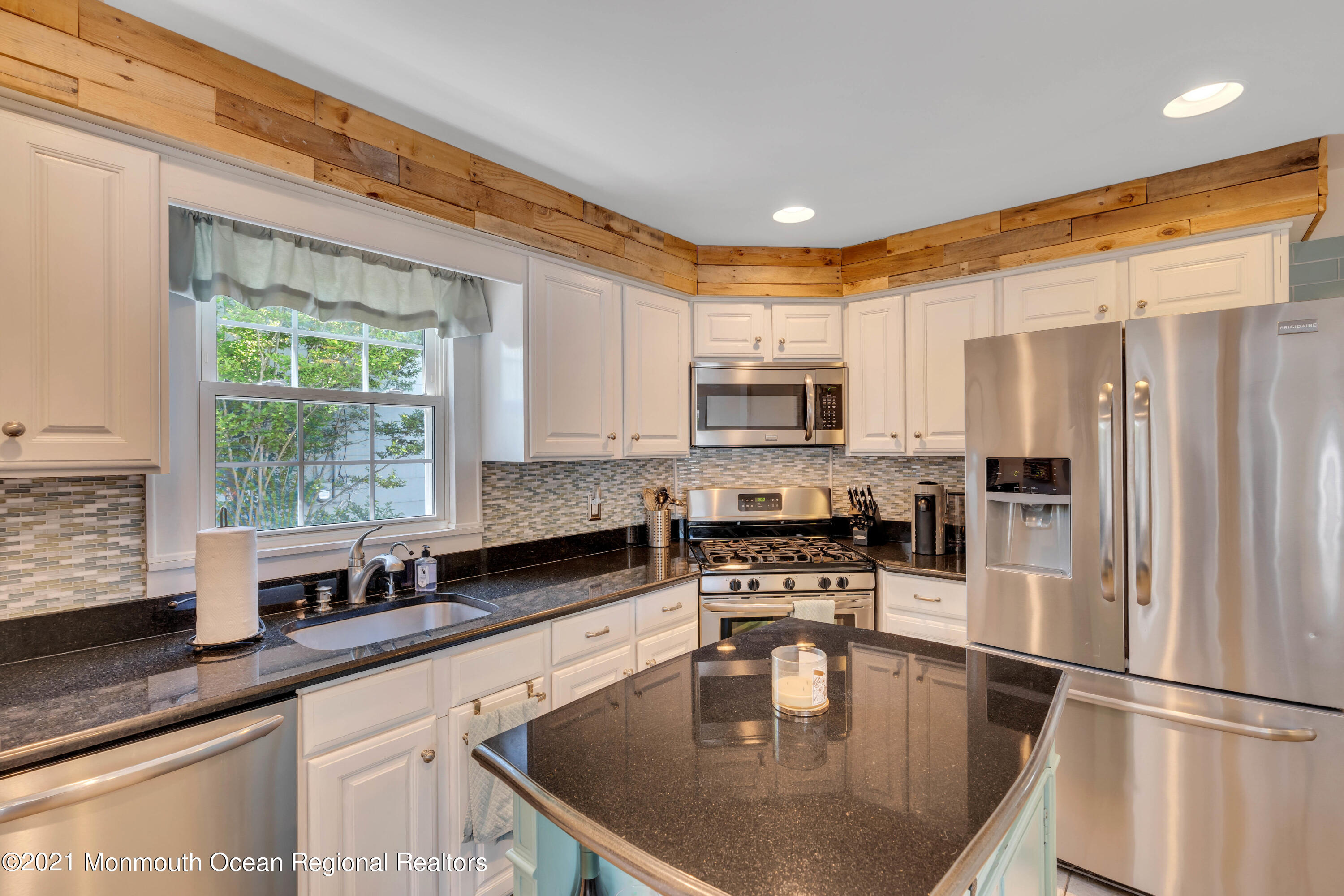 2212 Kenneth Road Point Pleasant, NJ 08742 - Photo 13 of 43 a kitchen with stainless steel appliances granite countertop a sink a stove and a window