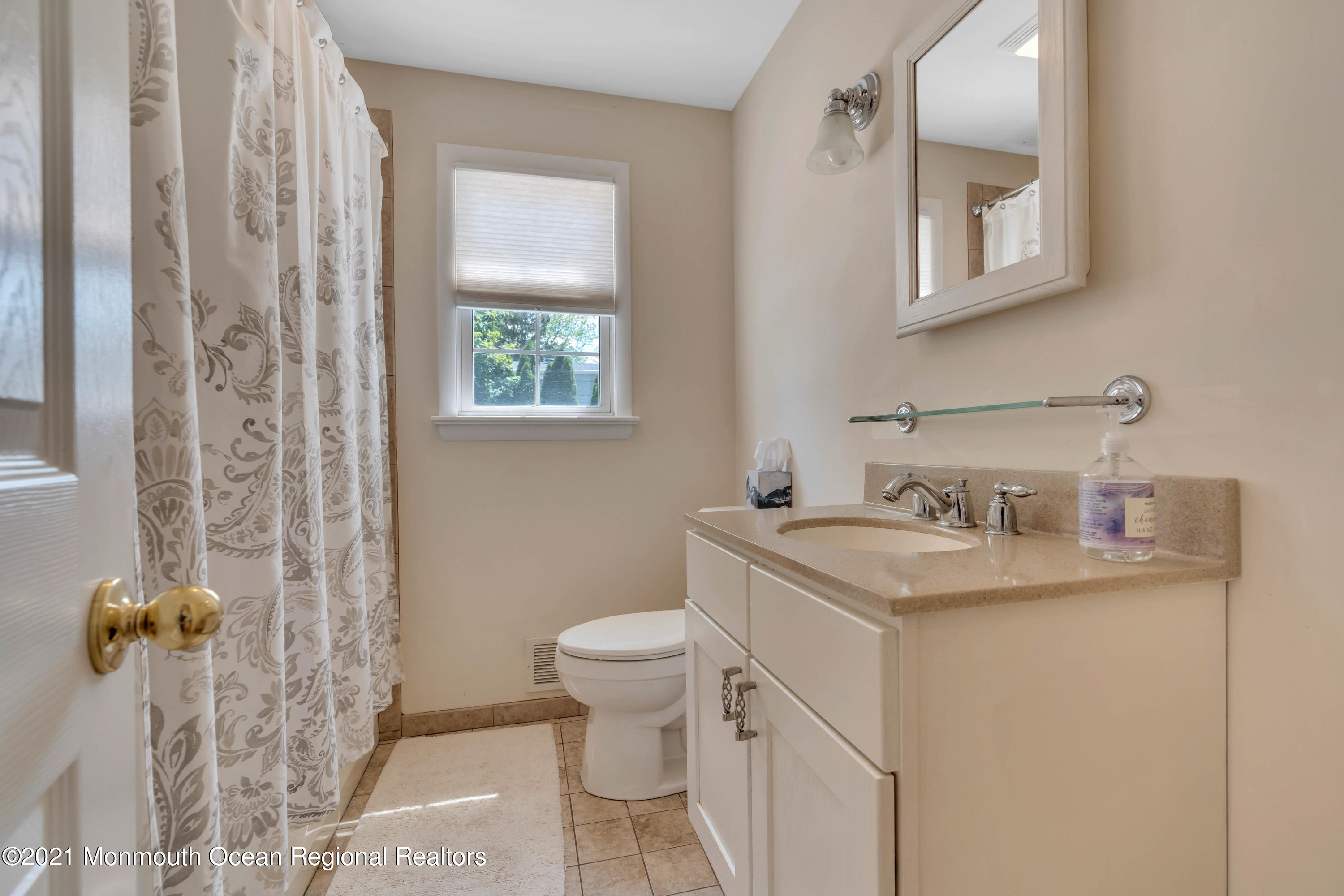 2212 Kenneth Road Point Pleasant, NJ 08742 - Photo 22 of 43 a bathroom with a granite countertop sink a toilet and a mirror