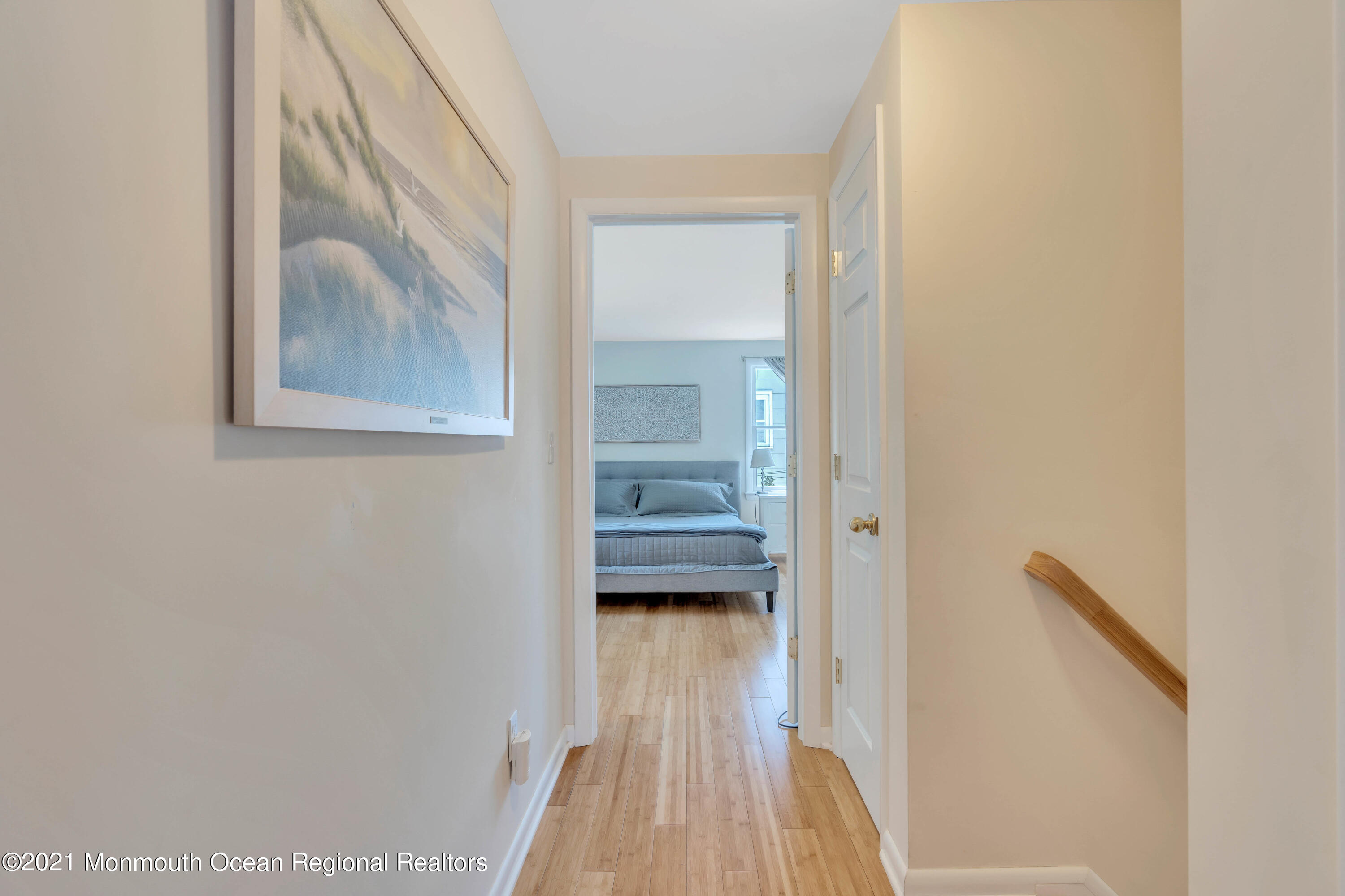 2212 Kenneth Road Point Pleasant, NJ 08742 - Photo 32 of 43 a view of a hallway with wooden floor and a livingroom